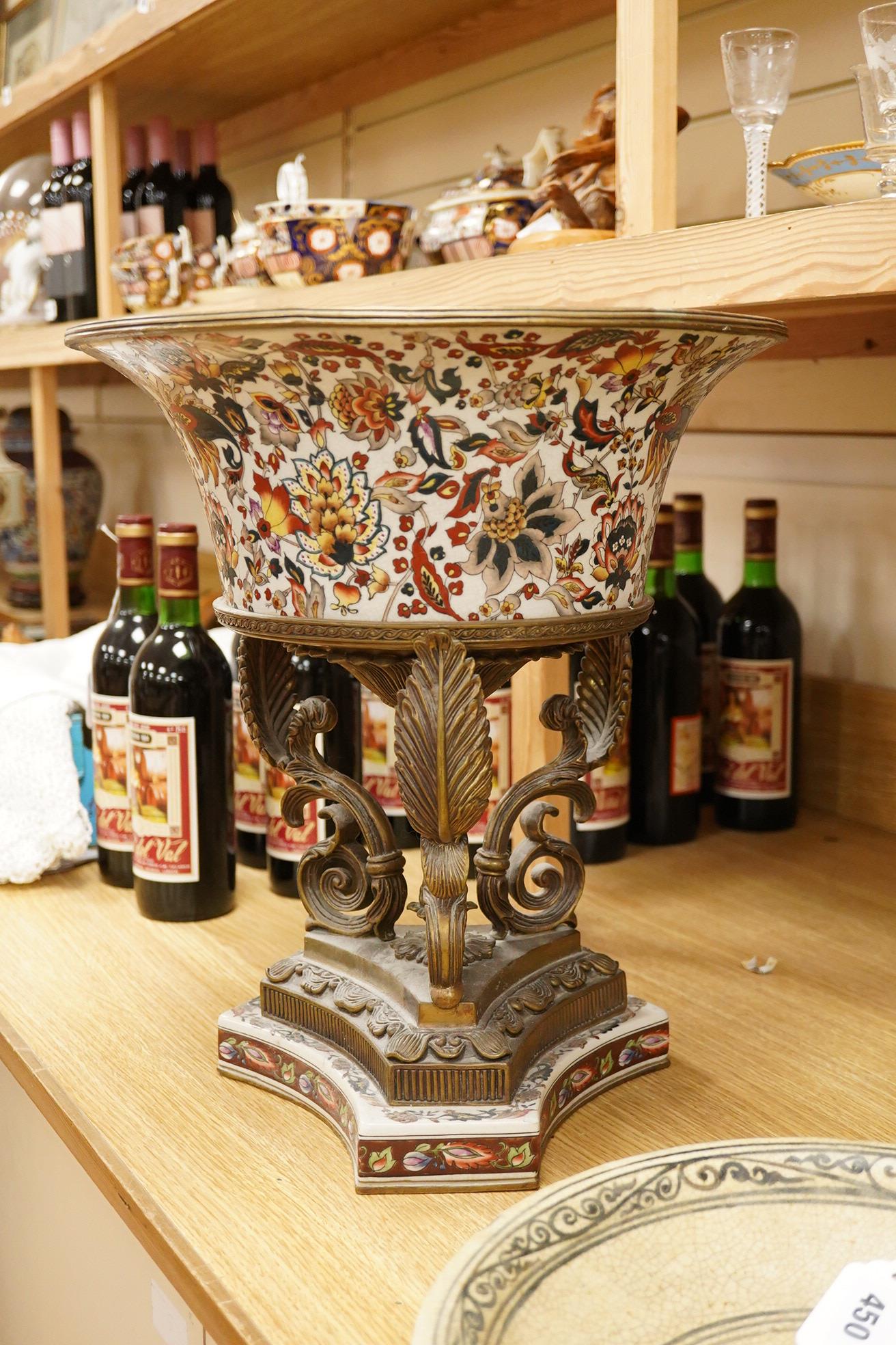 An early 20th century enamelled porcelain and ormolu mounted centrepiece with tripod scroll base, 41cm high